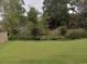 Peaceful backyard with pond and lush green landscaping at 1023 Meares St., Calabash, NC 28467