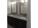 Double vanity bathroom with granite countertops and large mirrors at 1023 Meares St., Calabash, NC 28467