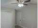 Bright bedroom with ceiling fan, double closet, and door leading to hallway at 1023 Meares St., Calabash, NC 28467