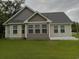 House exterior showcasing a two-tone design and a deck at 1023 Meares St., Calabash, NC 28467