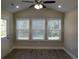 Bright sunroom with three windows and wood-look floors at 1023 Meares St., Calabash, NC 28467