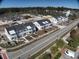 An aerial view of new townhomes, showcasing their layout, landscaping, and proximity to a road and nearby construction at 821 Rebecca Ln. # 6A, Myrtle Beach, SC 29577