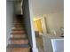 Unfinished wood stairway with white handrail leads to partially finished kitchen at 821 Rebecca Ln. # 6A, Myrtle Beach, SC 29577