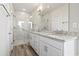 The bathroom features a double vanity with granite countertops, a large mirror, and a glass-enclosed shower at 1316 Marina Bay Dr., North Myrtle Beach, SC 29582