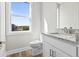 Bright bathroom features a white vanity with granite countertop and a view from the window at 1316 Marina Bay Dr., North Myrtle Beach, SC 29582