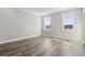 This bright bedroom features wood-look flooring, white trim and two windows at 1316 Marina Bay Dr., North Myrtle Beach, SC 29582