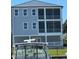 Three-story house with screened-in porches and a boat in the foreground at 1316 Marina Bay Dr., North Myrtle Beach, SC 29582
