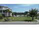 Vacant lot with marina view and neighboring houses at 1316 Marina Bay Dr., North Myrtle Beach, SC 29582