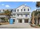 New construction home with a three-car garage, balcony, and white siding at 410 5Th Ave. S, North Myrtle Beach, SC 29582