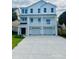 Stunning three-story white home with a charming balcony and a spacious two-car garage at 410 5Th Ave. S, North Myrtle Beach, SC 29582