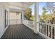 A cozy outdoor porch with white railings and wood floors, perfect for relaxing at 410 5Th Ave. S, North Myrtle Beach, SC 29582