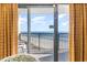 Stunning ocean view from inside the condo, featuring a balcony at 4800 S Ocean Blvd. # 824, North Myrtle Beach, SC 29582