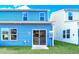 Light blue home with sliding glass door leading to a patio at 718 Nw Palm Frond Way # 66, Calabash, NC 28467