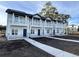 Townhomes with covered balconies and white pillars with gray brick detail along the bottom at 821 Maxine Ct. # 2D, Myrtle Beach, SC 29577