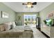 Light-filled bedroom with a view to the outside, includes a comfortable queen bed, dresser, and calming decor at 4396 Baldwin Ave. # 47, Little River, SC 29566