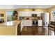 Bright kitchen featuring granite countertops, white cabinets, stainless steel appliances, and wood floors at 4396 Baldwin Ave. # 47, Little River, SC 29566