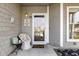 Inviting front porch with a charming chair, decor, and view of the marina at 4396 Baldwin Ave. # 47, Little River, SC 29566