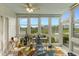 Bright sunroom with floor-to-ceiling windows, a ceiling fan, and a cheerful rug creates a relaxing place to unwind at 4396 Baldwin Ave. # 47, Little River, SC 29566