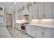 Gourmet kitchen with white cabinets, stainless steel appliances, and marble countertops at 5146 Middleton View Dr., Myrtle Beach, SC 29579
