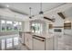 Open-concept kitchen with island, farmhouse sink, and views of the living area and backyard at 5146 Middleton View Dr., Myrtle Beach, SC 29579