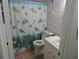 Bathroom with seashell shower curtain and light fixtures at 6305 N Ocean Blvd. # B-3, North Myrtle Beach, SC 29582