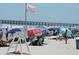 Crowded beach with pier in background, umbrellas and chairs at 6305 N Ocean Blvd. # B-3, North Myrtle Beach, SC 29582