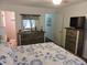 Bedroom with dresser, coastal bedding, and access to bathroom at 6305 N Ocean Blvd. # B-3, North Myrtle Beach, SC 29582