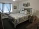 Bedroom with coastal bedding and rustic wooden furniture at 6305 N Ocean Blvd. # B-3, North Myrtle Beach, SC 29582