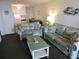 Open living room and kitchen area with coastal decor at 6305 N Ocean Blvd. # B-3, North Myrtle Beach, SC 29582
