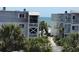 Partial ocean view from balcony, with lush tropical foliage at 6305 N Ocean Blvd. # B-3, North Myrtle Beach, SC 29582
