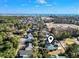 An aerial view of a light blue home near a neighborhood surrounded by trees and the ocean at 1604 James Island Ave., North Myrtle Beach, SC 29582