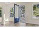 Bright entryway with a blue front door, white trim, and hardwood floors at 1604 James Island Ave., North Myrtle Beach, SC 29582