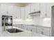 Bright, modern kitchen featuring white cabinets, stainless steel appliances, and a stylish countertop at 1604 James Island Ave., North Myrtle Beach, SC 29582