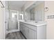 Bathroom with double vanity with granite countertop, a glass enclosed shower and wood look flooring at 2401 Duffy St., North Myrtle Beach, SC 29582