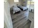 Inviting bedroom featuring two beds, wood-look floors, balcony access and dresser at 2401 Duffy St., North Myrtle Beach, SC 29582