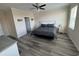 Well-lit primary bedroom with neutral walls, ceiling fan, and wood flooring at 2401 Duffy St., North Myrtle Beach, SC 29582