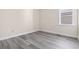 Bright, empty room with neutral walls, base trim, and wood-look flooring, ready for personal customization at 2401 Duffy St., North Myrtle Beach, SC 29582