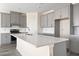 Well-designed kitchen with gray cabinetry, granite countertops, and stainless steel appliances at 2401 Duffy St., North Myrtle Beach, SC 29582