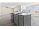 Open kitchen with granite island and stainless steel dishwasher, and sink with views to the living room at 2401 Duffy St., North Myrtle Beach, SC 29582