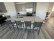 Open kitchen featuring stainless appliances, an oversized island with granite countertops, and light gray cabinets at 2401 Duffy St., North Myrtle Beach, SC 29582