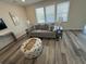 Comfortable living room with a gray sofa, decorative pillows, patterned ottoman, and natural light from the window at 2401 Duffy St., North Myrtle Beach, SC 29582