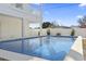 Backyard pool featuring clear blue water and stone accents, with a partial view of the home's white siding at 2401 Duffy St., North Myrtle Beach, SC 29582