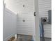 Outdoor shower with a white privacy fence and siding and paver flooring at 2401 Duffy St., North Myrtle Beach, SC 29582