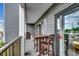 Spacious outdoor balcony seating area with a dining table and balcony railings at 5905 S Kings Hwy. # A 115, Myrtle Beach, SC 29575
