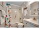 Well-lit bathroom features a tub/shower combo with colorful curtain and white vanity at 5905 S Kings Hwy. # A 115, Myrtle Beach, SC 29575