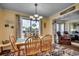 Sunny dining room with a wood table and chairs and a sliding glass door to the outdoor balcony, beachy decor at 5905 S Kings Hwy. # A 115, Myrtle Beach, SC 29575