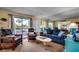 Relax in this sunny living room with comfortable seating, large windows, and a view of palm trees at 5905 S Kings Hwy. # A 115, Myrtle Beach, SC 29575