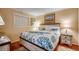 Comfortable bedroom with queen bed, nautical-themed bedding, and warm lighting at 5905 S Kings Hwy. # A 115, Myrtle Beach, SC 29575
