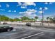 Wide view of a parking lot with parking spaces, landscaping, and clear blue sky at 5905 S Kings Hwy. # A 115, Myrtle Beach, SC 29575