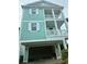 Striking 3-story home featuring dual balconies and a covered garage space at 1207 Salt Windy Way, North Myrtle Beach, SC 29582